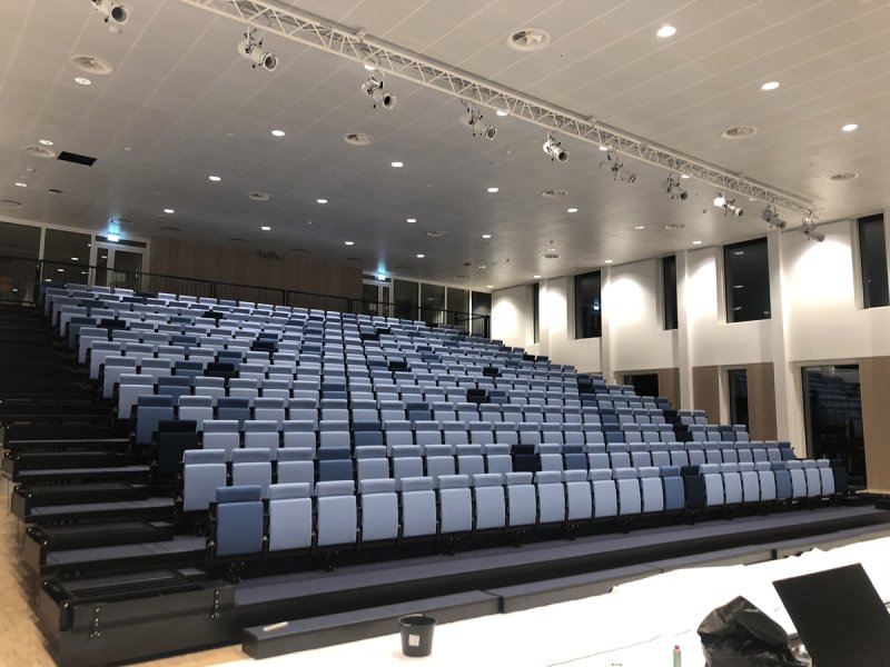 Auditorium Hempel SA headquarters in Denmark. Fully automatically operated  COS retractable grandstand.