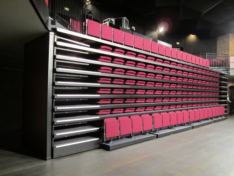 Centre Culturel L'Escapade in the city of Henin Beaumont France. Retractable grandstand with rigid chain, fully automatically operated chairs.