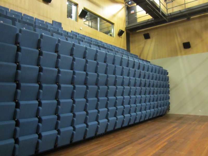 Closed telescopic grandstand in Blue hall of Theater De Bussel Oosterhout, The Netherlands