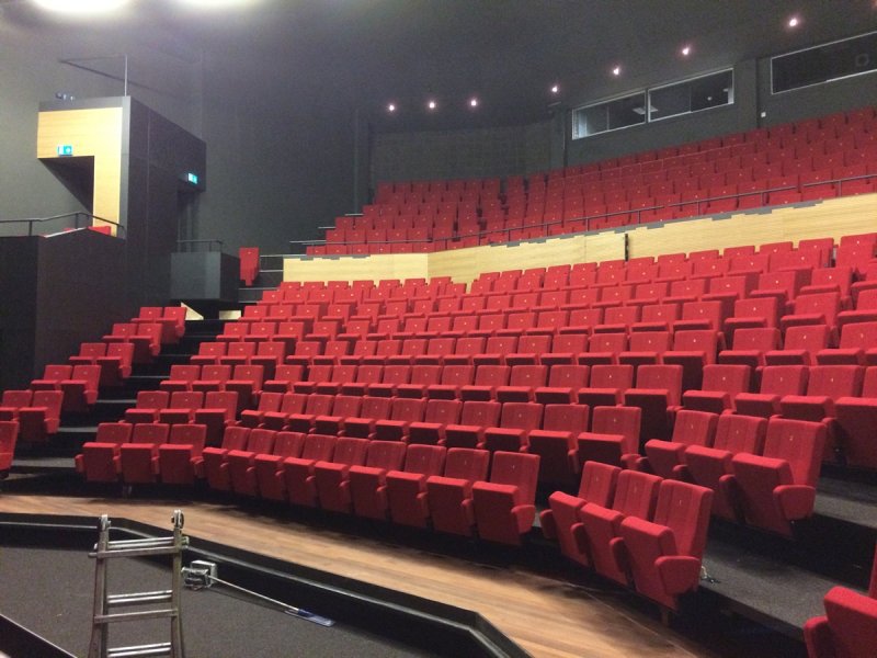 Retractable grandstand connected to angular shaped fixed balcony in Theater De Bussel Oosterhout, The Netherlands